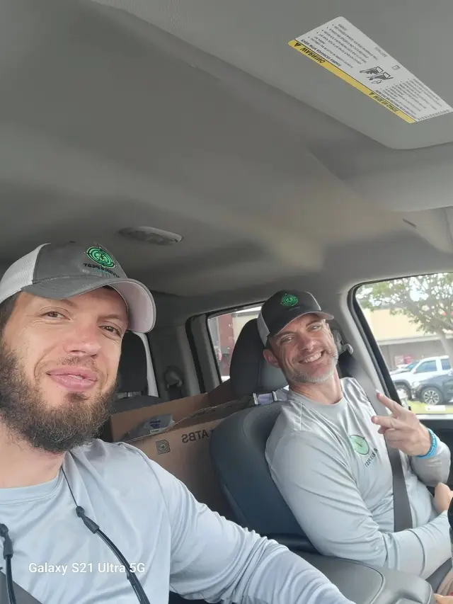 Two Rivers technicians sitting in the cab of a truck