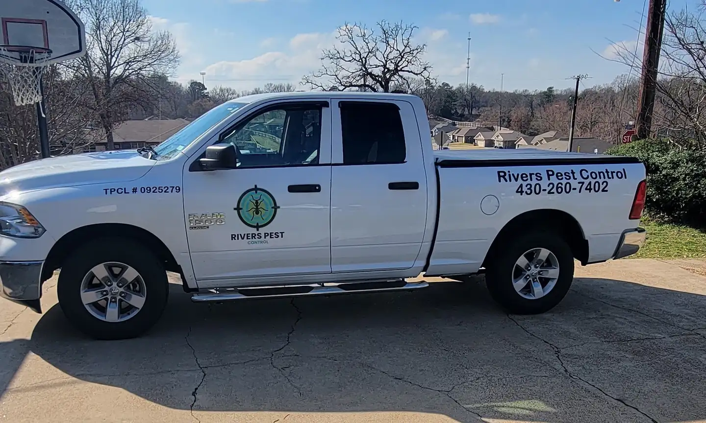 A white Rivers Pest Control Ram parked on a customer's driveway on a clear winter day
